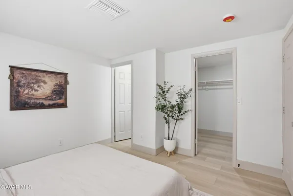 a view of a room with wooden floor and a potted plant