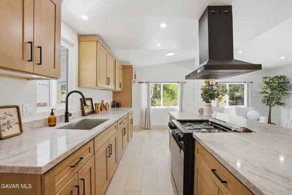 a kitchen with lots of counter top space and windows