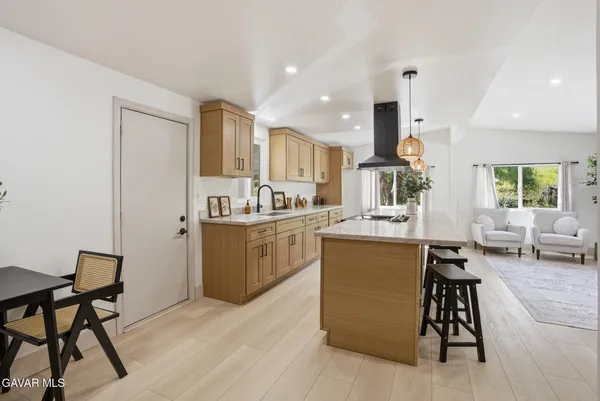 a living room with furniture and kitchen view