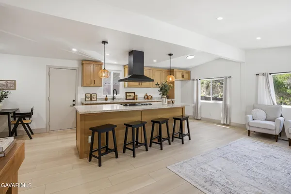 a large kitchen with a table and chairs