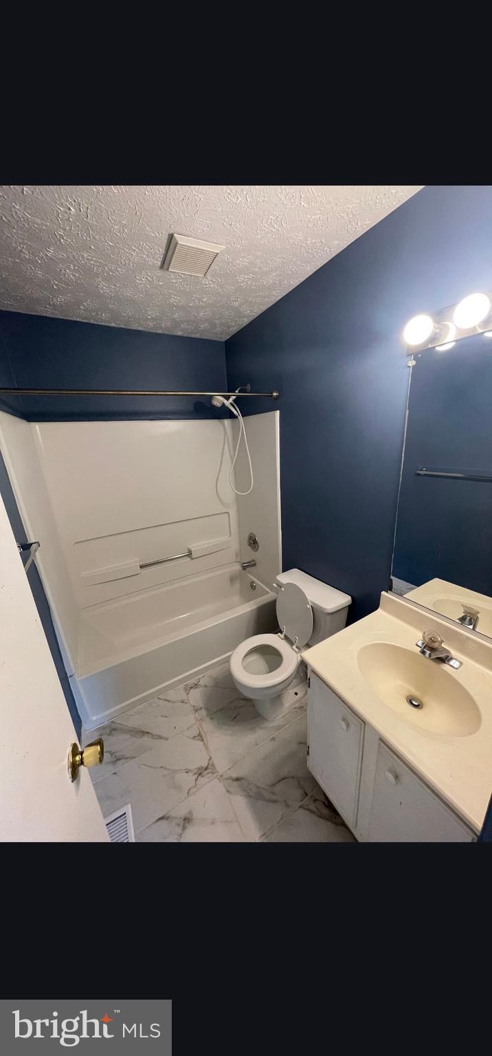 822 Joshua Tree Court Owings Mills, MD 21117 - Photo 11 of 27 a bathroom with a sink a toilet and a mirror