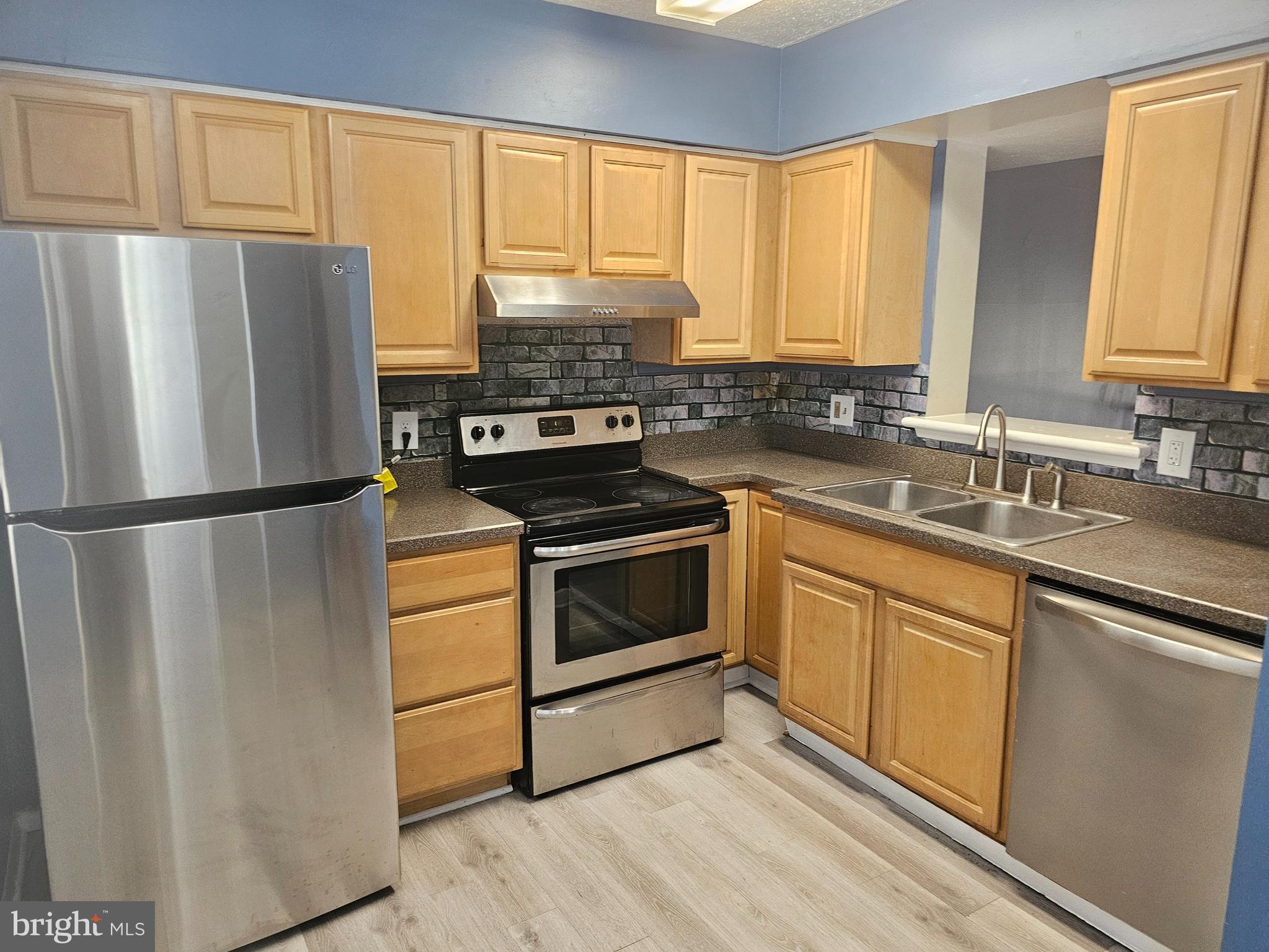 822 Joshua Tree Court Owings Mills, MD 21117 - Photo 2 of 27 a kitchen with a refrigerator stove and sink