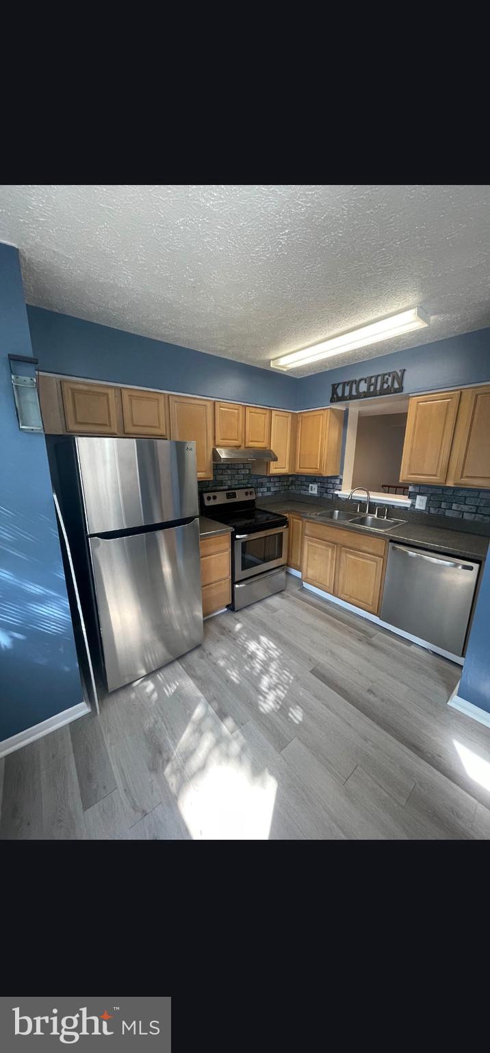 822 Joshua Tree Court Owings Mills, MD 21117 - Photo 24 of 27 a view of kitchen with cabinets and wooden floor