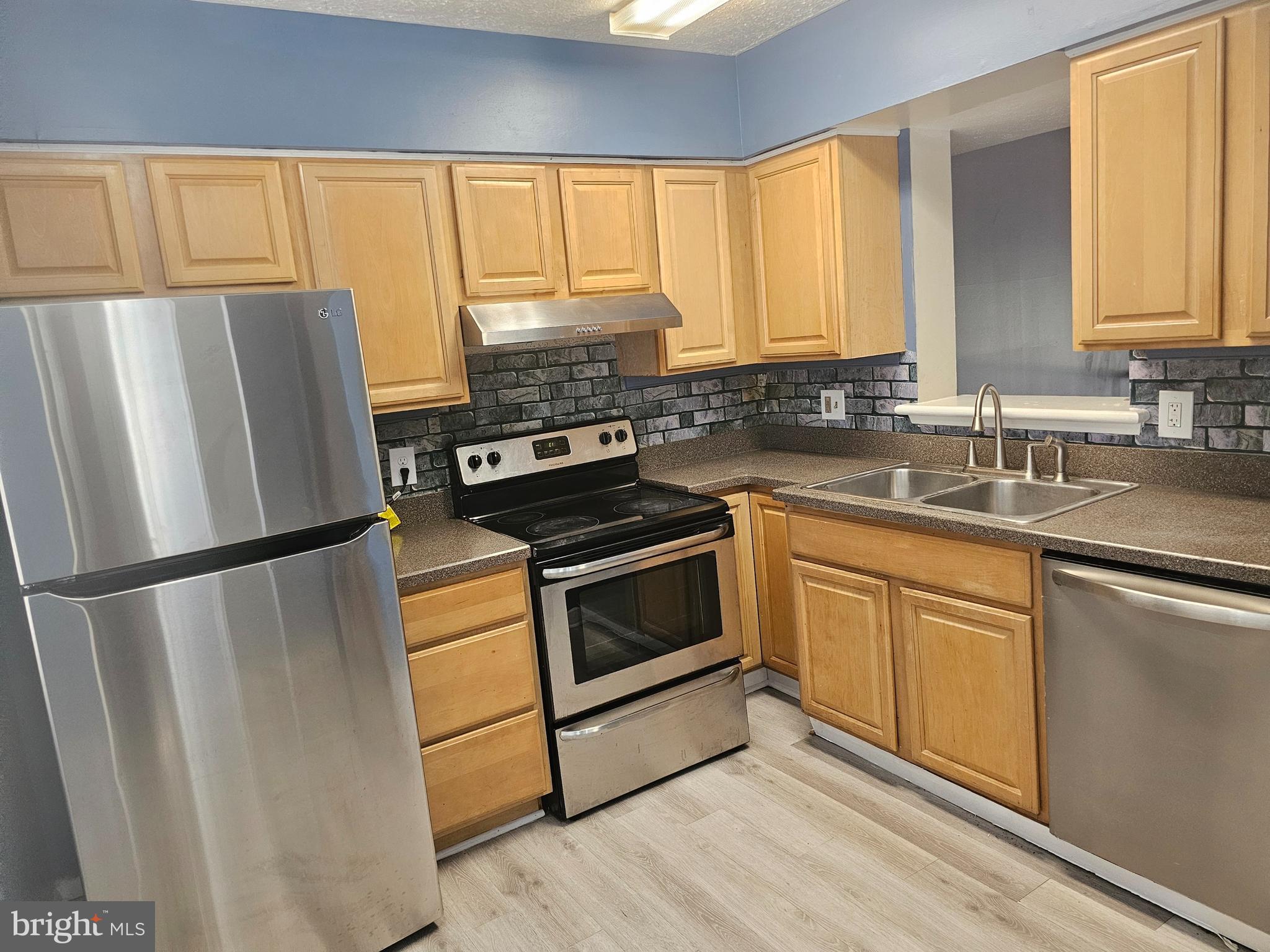822 Joshua Tree Court Owings Mills, MD 21117 - Photo 3 of 27 a kitchen with a refrigerator sink and window