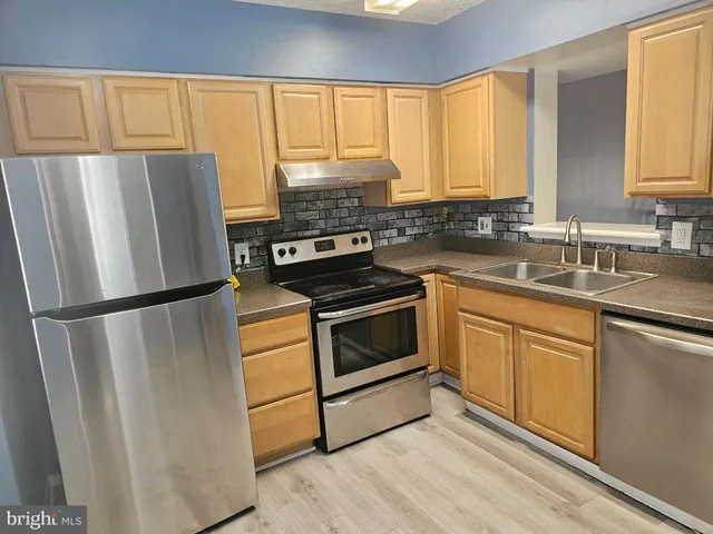 a kitchen with a refrigerator stove and microwave