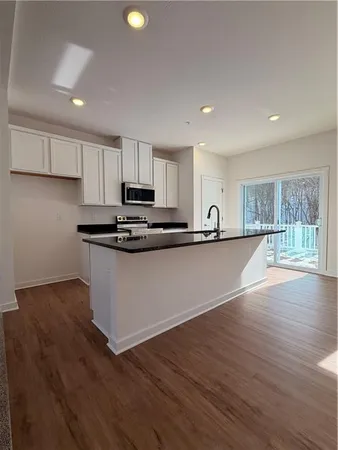 a view of kitchen with sink and wooden floor