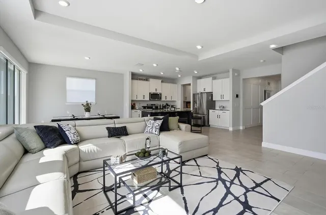 a living room with furniture and kitchen view