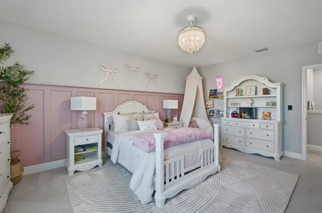 a bedroom with a bed and a chandelier