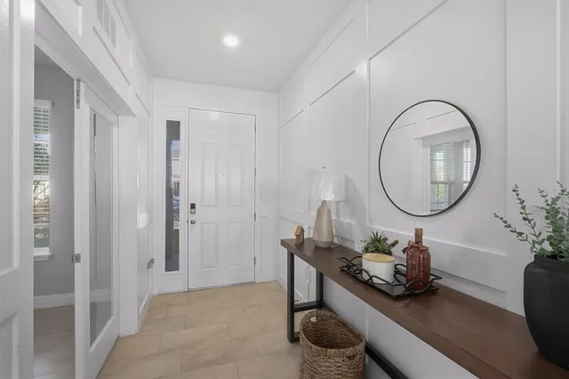 a room with a table chair and a potted plant