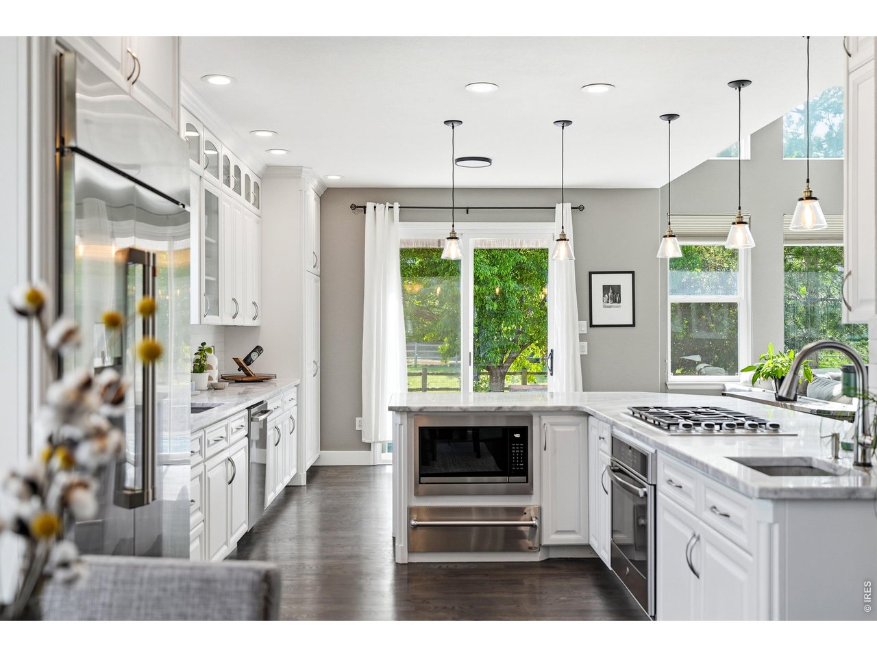 11725 Pleasant Hill Road Longmont, CO 80504 - Photo 15 of 50 Updated counters, fresh paint, subway tile backsplash, stainless steel appliances, modern accent lighting, ample workspace, and a large window over the sink