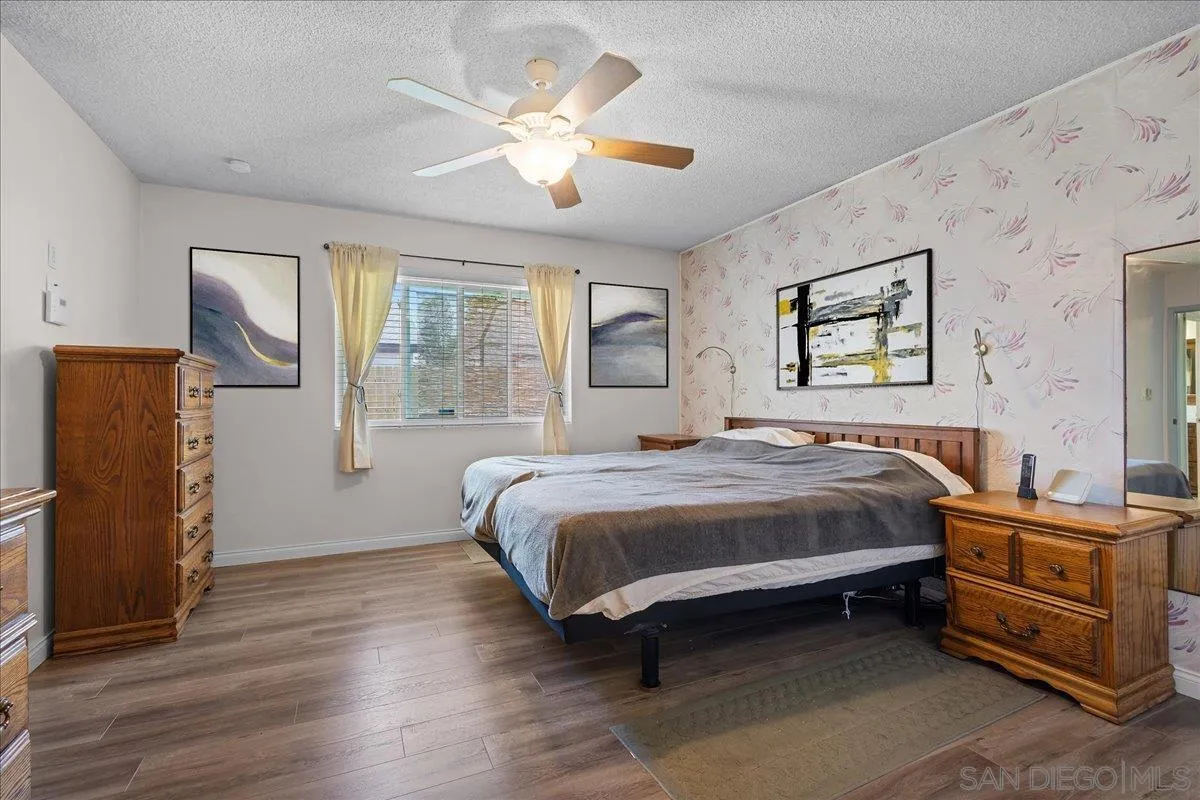 10738 2nd Street Santee, CA 92071 - Photo 24 of 52 a bedroom with a bed and wooden floor
