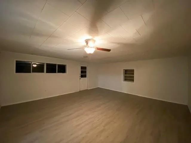 an empty room with a empty space and windows