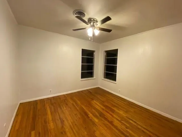 a view of an empty room with a window and closet