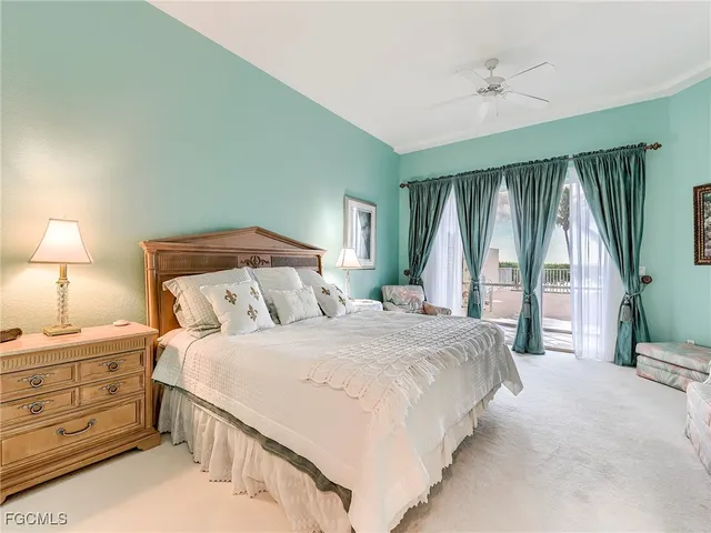 a bedroom with a large bed and a large window