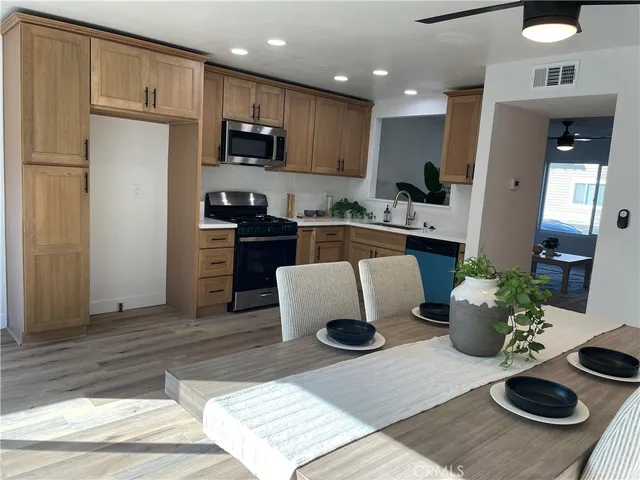 a kitchen with a refrigerator and a stove top oven