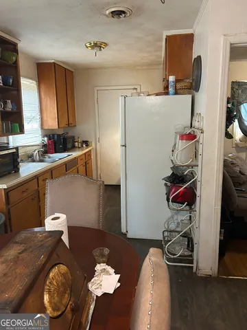 a kitchen with a refrigerator a counter top space and a window