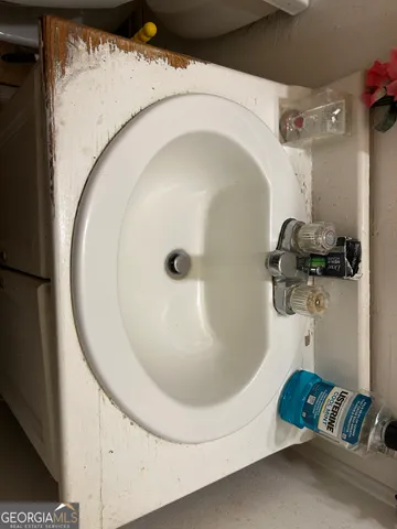 a white toilet sitting next to a sink and vanity