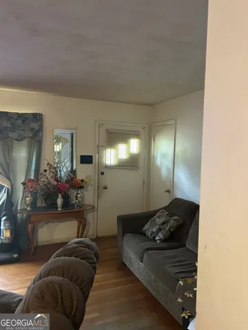 a living room with furniture and a lamp