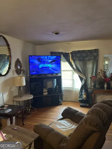 a bedroom with a bed a bookshelf and a fireplace