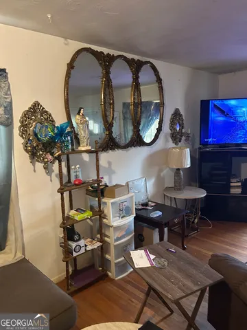 a living room with furniture and a mirror