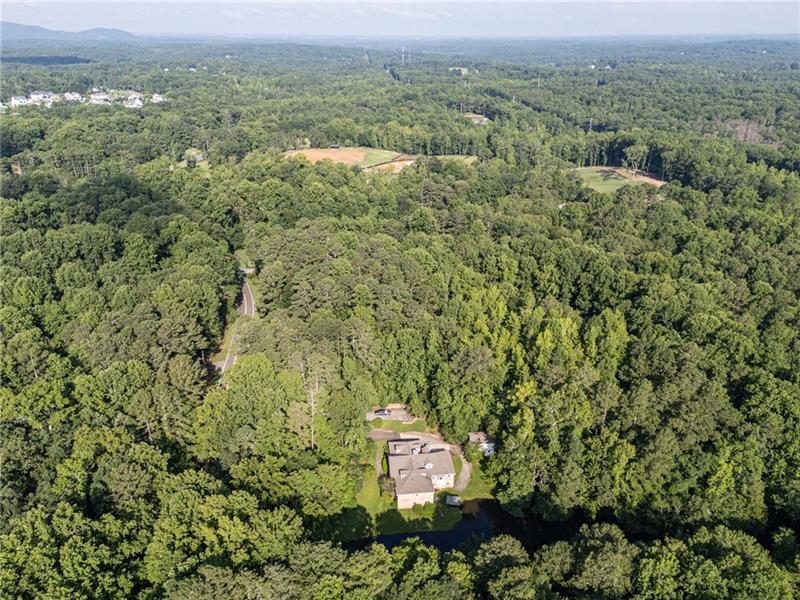 257 Ranchette Road Alpharetta, GA 30004 - Photo 8 of 17 a view of a green field with lots of bushes