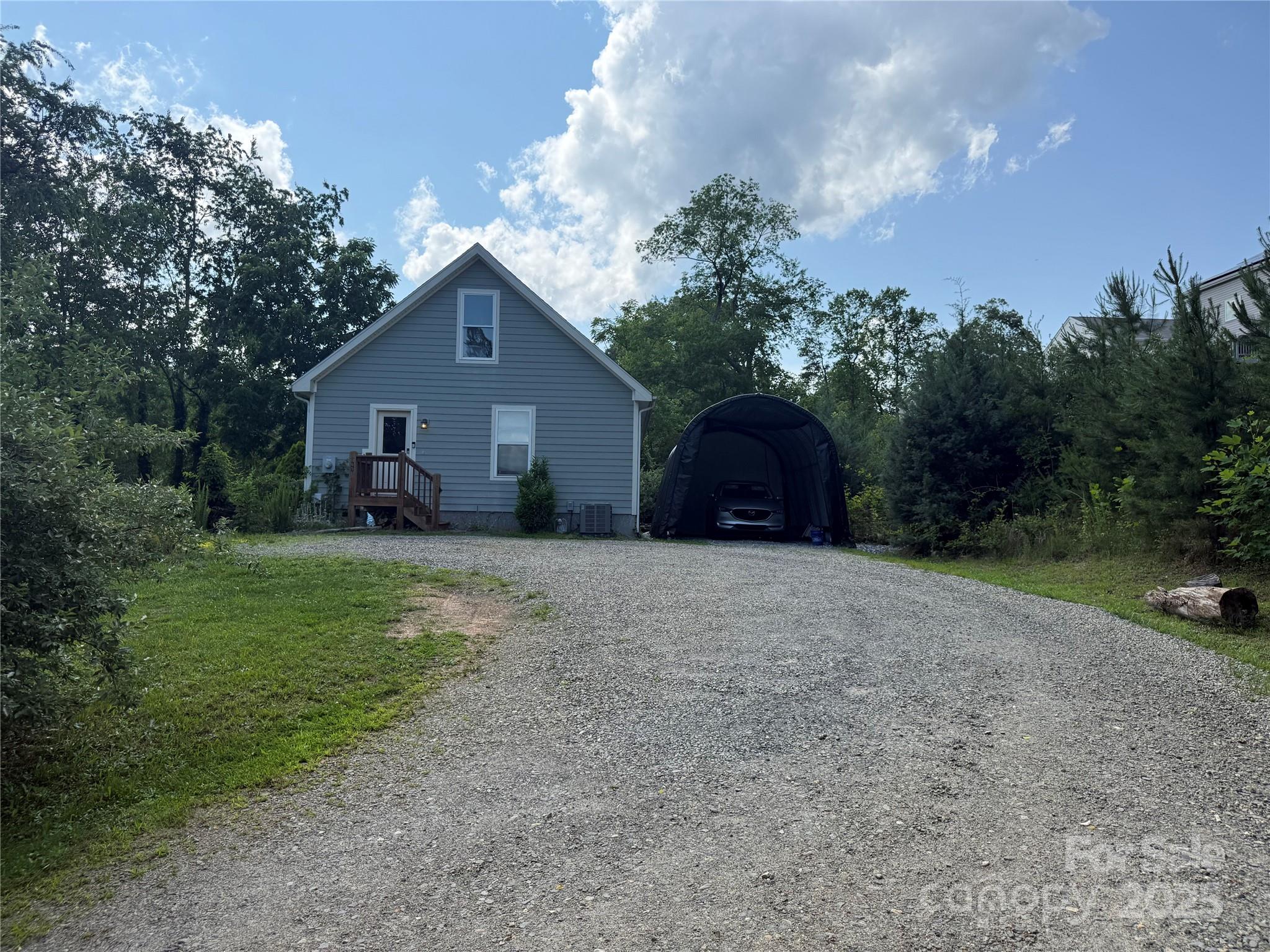 65 Owenby Road Candler, NC 28715 - Photo 3 of 8 a front view of a house with a yard and trees