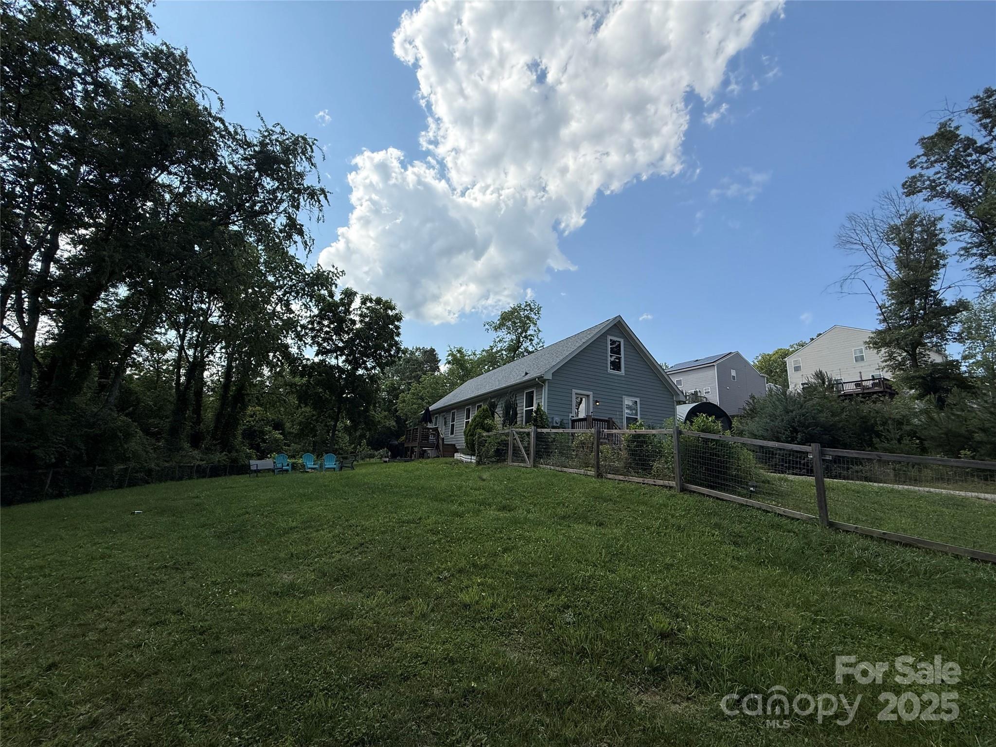 65 Owenby Road Candler, NC 28715 - Photo 4 of 8 a view of a house with a big yard and large trees