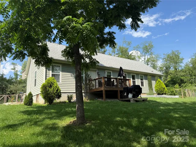 a front view of a house with a garden and trees