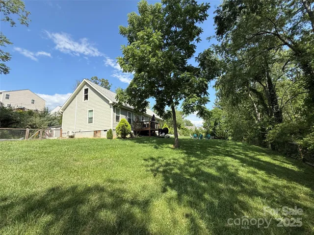 a view of a backyard with large trees