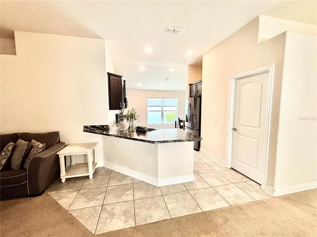 a kitchen with a sink and white cabinets