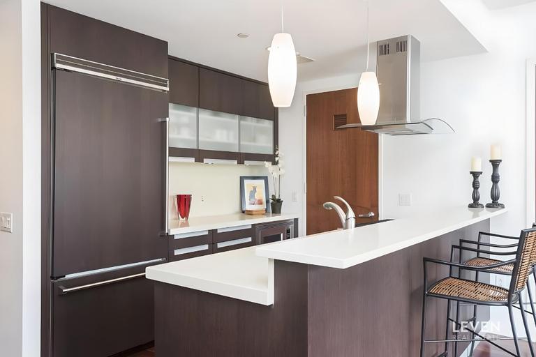 50 West 15th Street, Unit 8B Manhattan, NY 10011 - Photo 2 of 9 a kitchen with stainless steel appliances a sink and a refrigerator