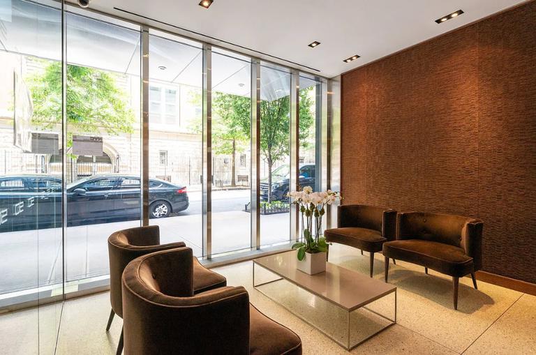 50 West 15th Street, Unit 8B Manhattan, NY 10011 - Photo 6 of 9 a living room with furniture and a floor to ceiling window