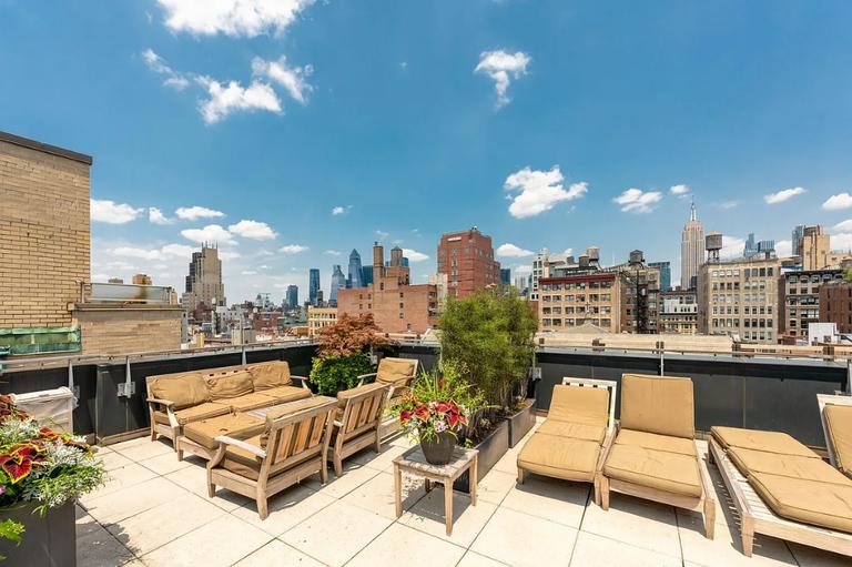 50 West 15th Street, Unit 8B Manhattan, NY 10011 - Photo 7 of 9 a dining room with furniture and a kitchen view