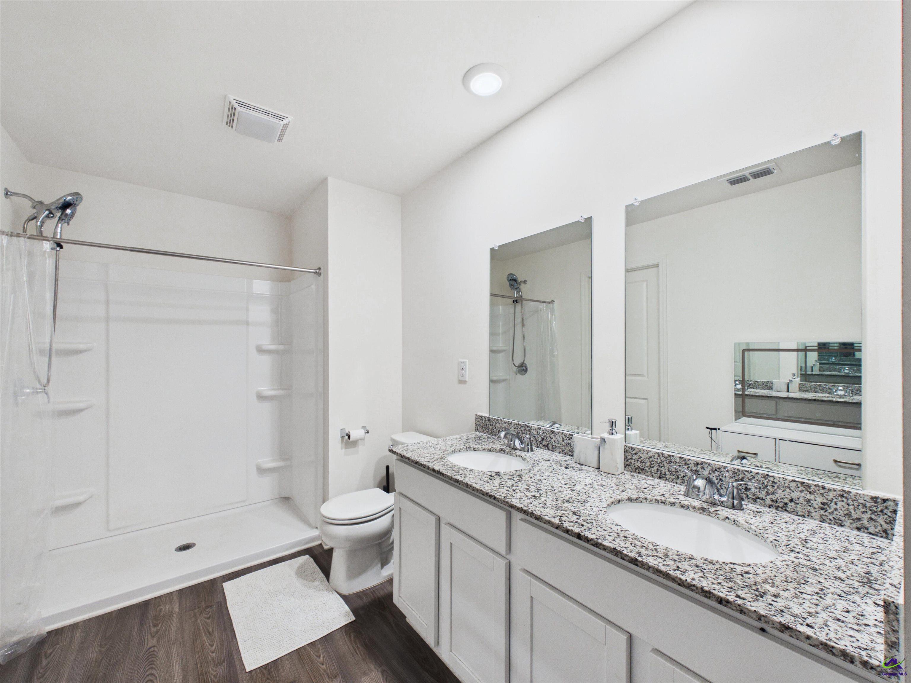 116 Jamie Court Fort Valley, GA 31030 - Photo 11 of 19 a bathroom with a granite countertop sink a toilet and shower