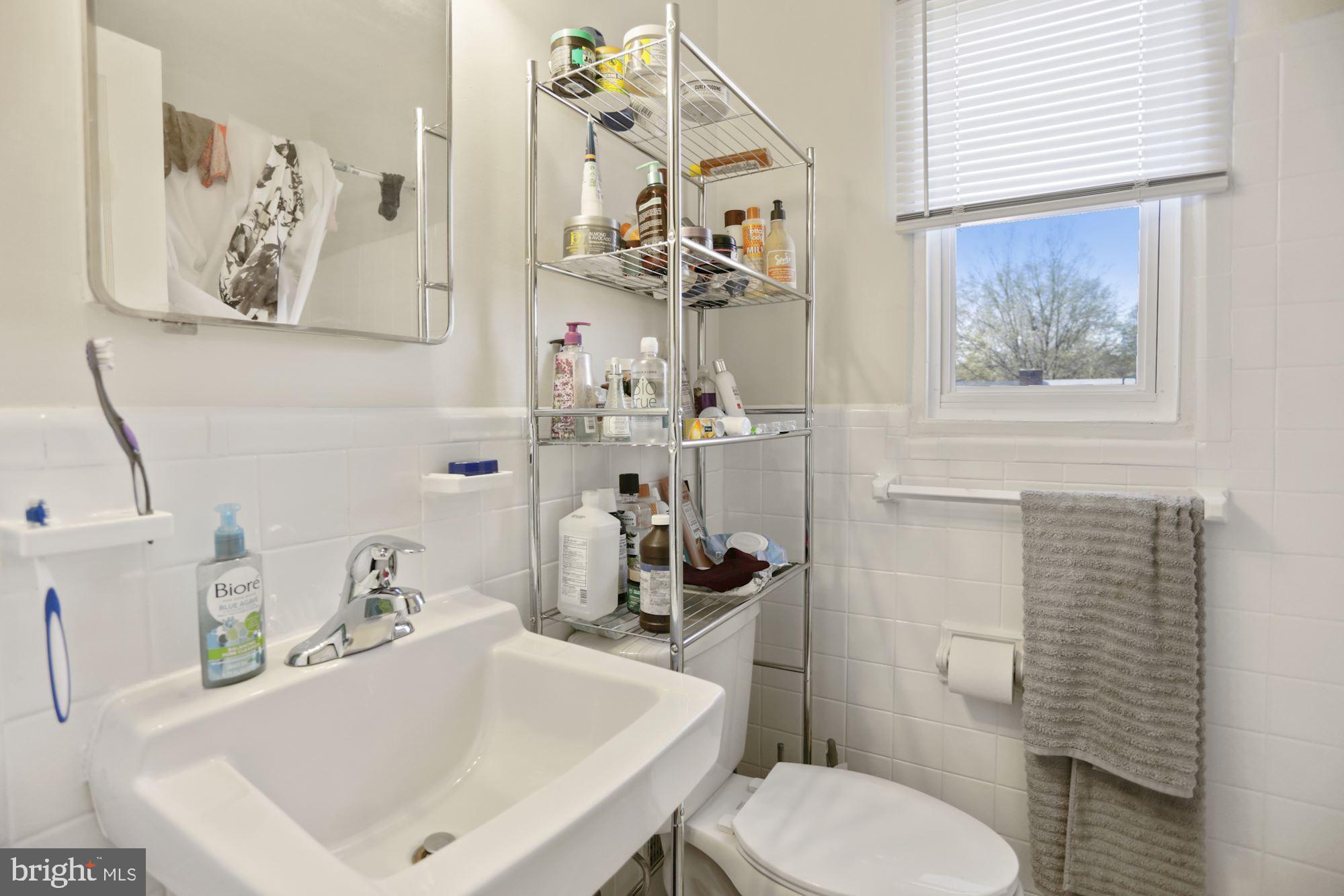 4910 Sargent Road Northeast Washington, DC 20017 - Photo 13 of 16 a bathroom with a sink mirror and toilet