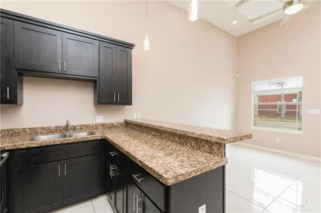 a kitchen with granite countertop cabinets sink and stove