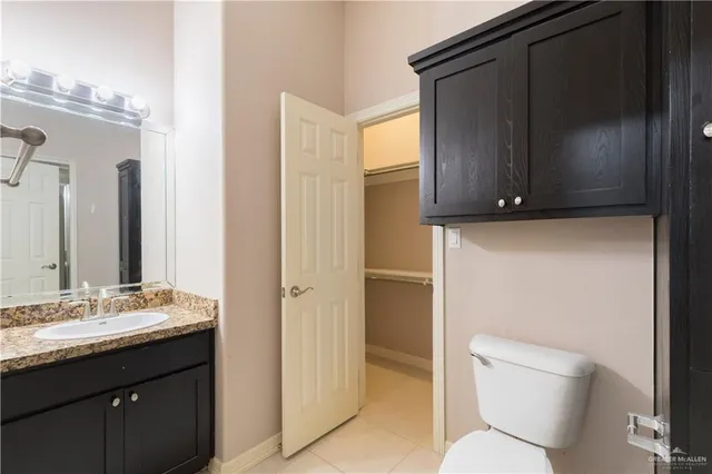 a bathroom with a toilet a sink and mirror