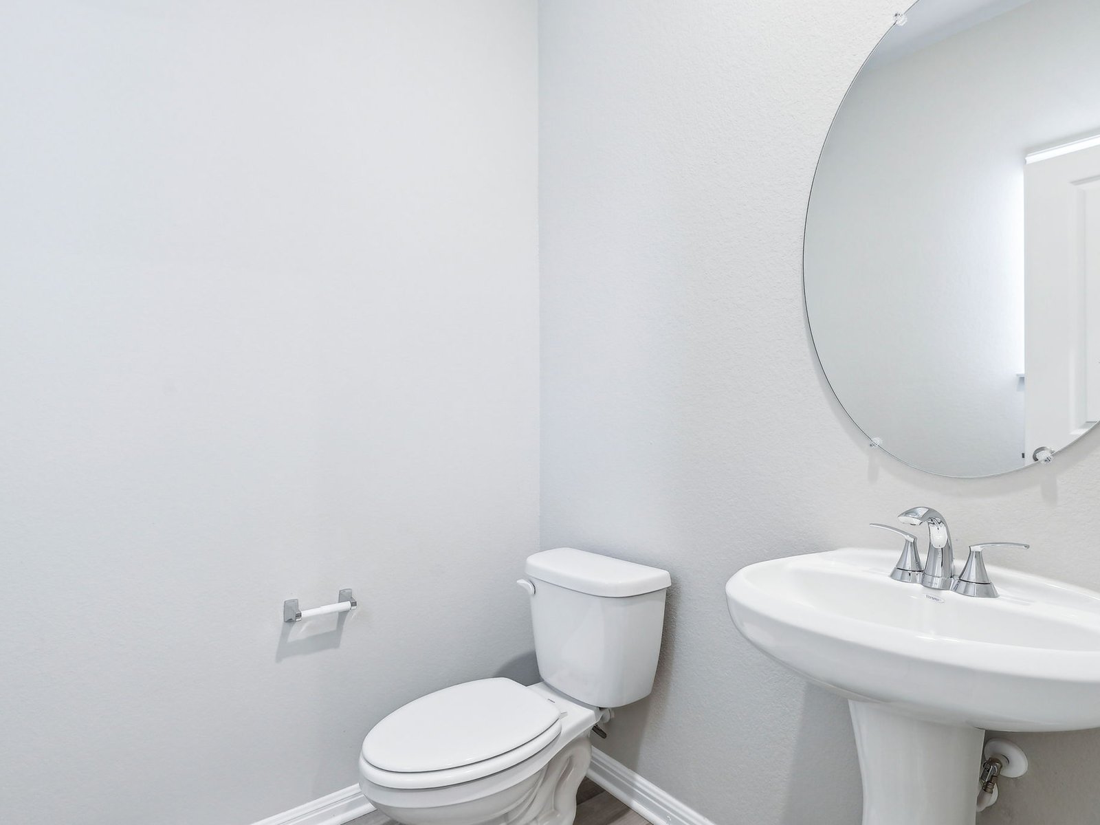 113 Maple Hedge Road Hutto, TX 78634 - Photo 10 of 20 a white toilet sitting next to a bathroom sink