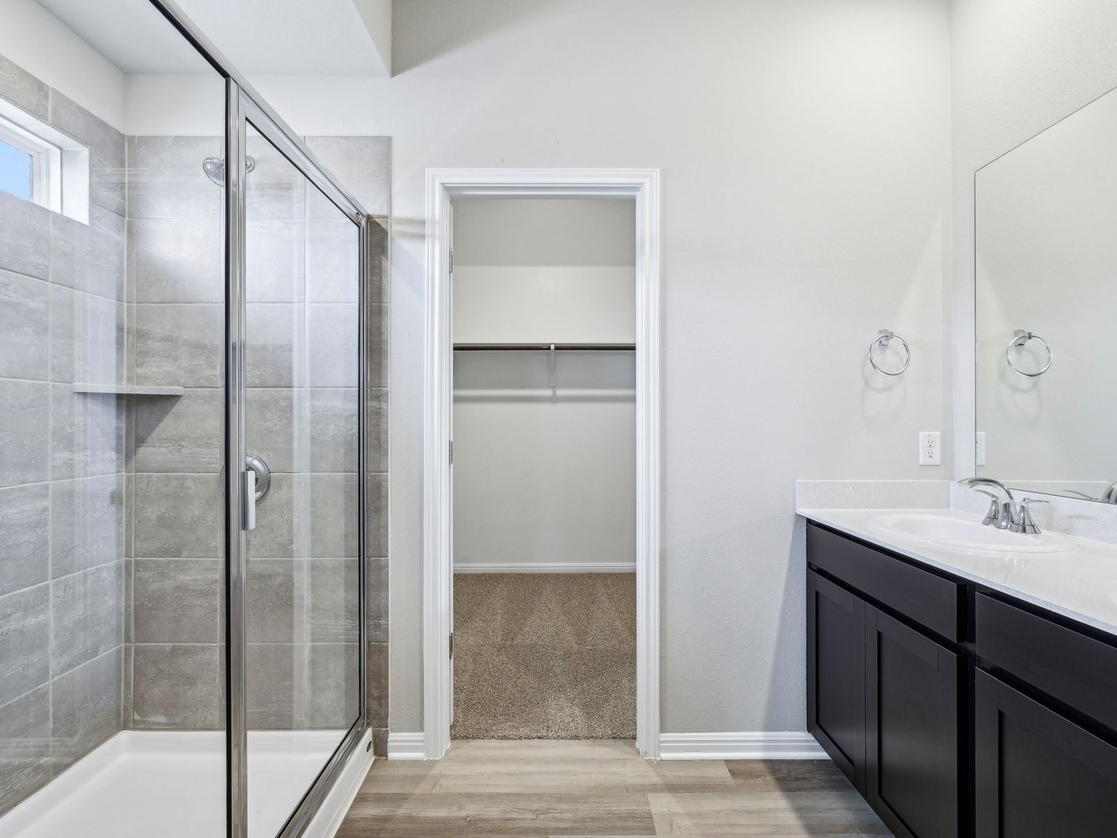 113 Maple Hedge Road Hutto, TX 78634 - Photo 12 of 20 a bathroom with a shower sink and mirror