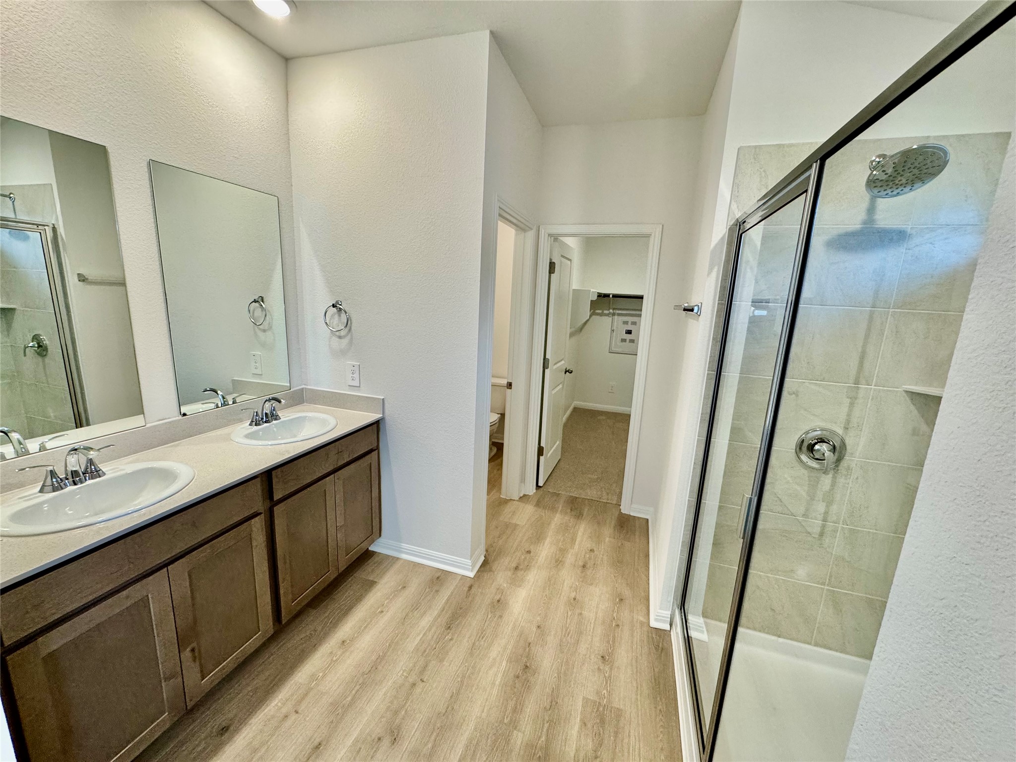 113 Maple Hedge Road Hutto, TX 78634 - Photo 4 of 20 a spacious bathroom with a double vanity sink a mirror and shower