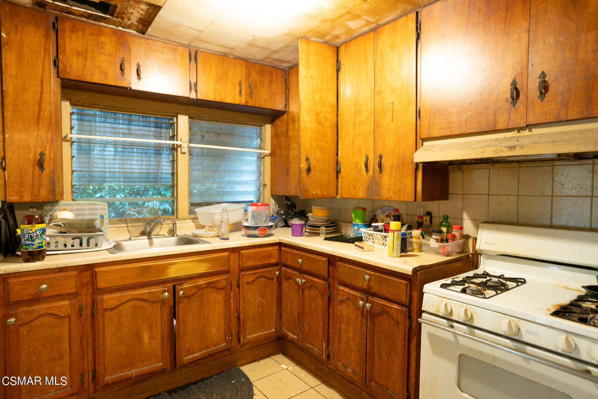 5829 Tipton Way Los Angeles, CA 90042 - Photo 4 of 20 a kitchen with a sink stove and cabinets