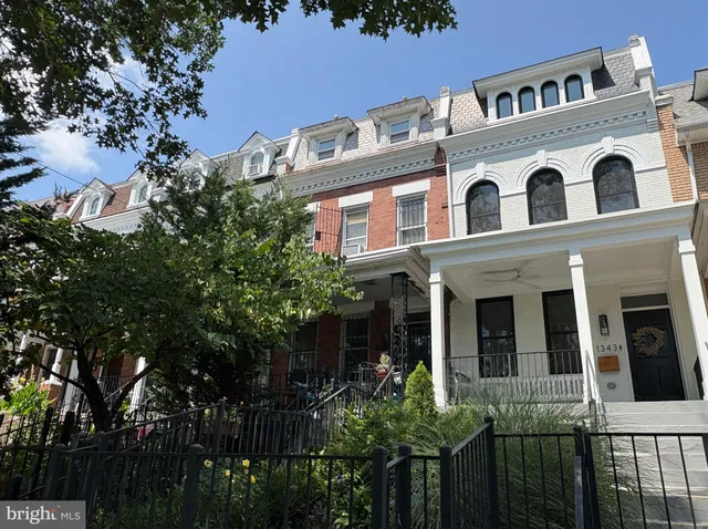 a large building with a tree in front of it