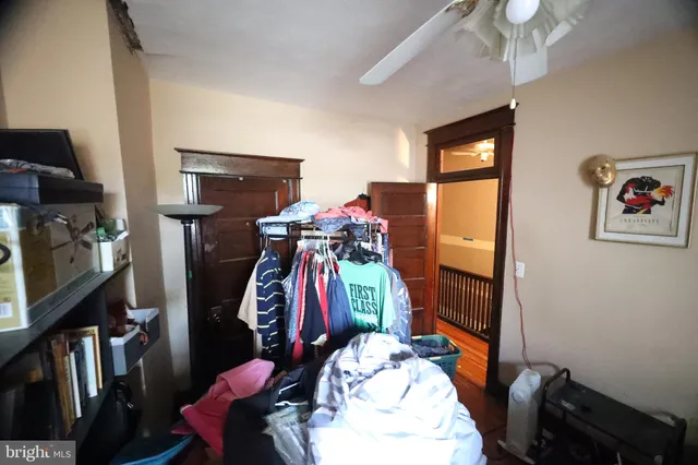a view of a hallway with wooden floor and a dining room