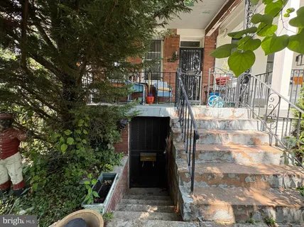 a view of living room and bathroom with a wooden floor