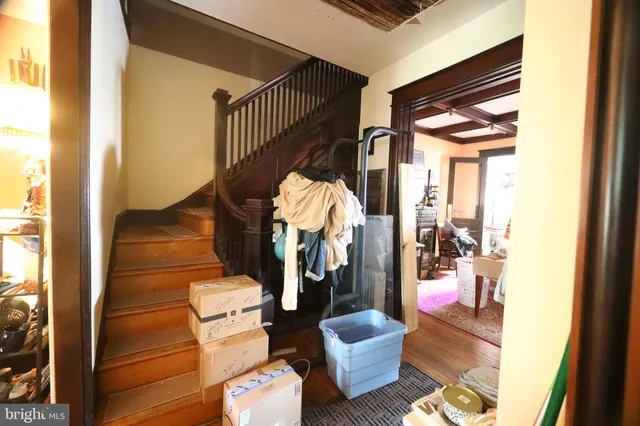 a view of entryway and hall with wooden floor