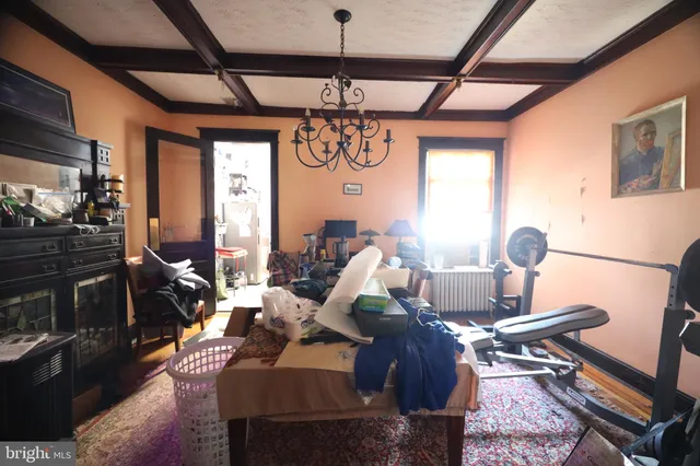 a living room with lots of furniture and chandelier