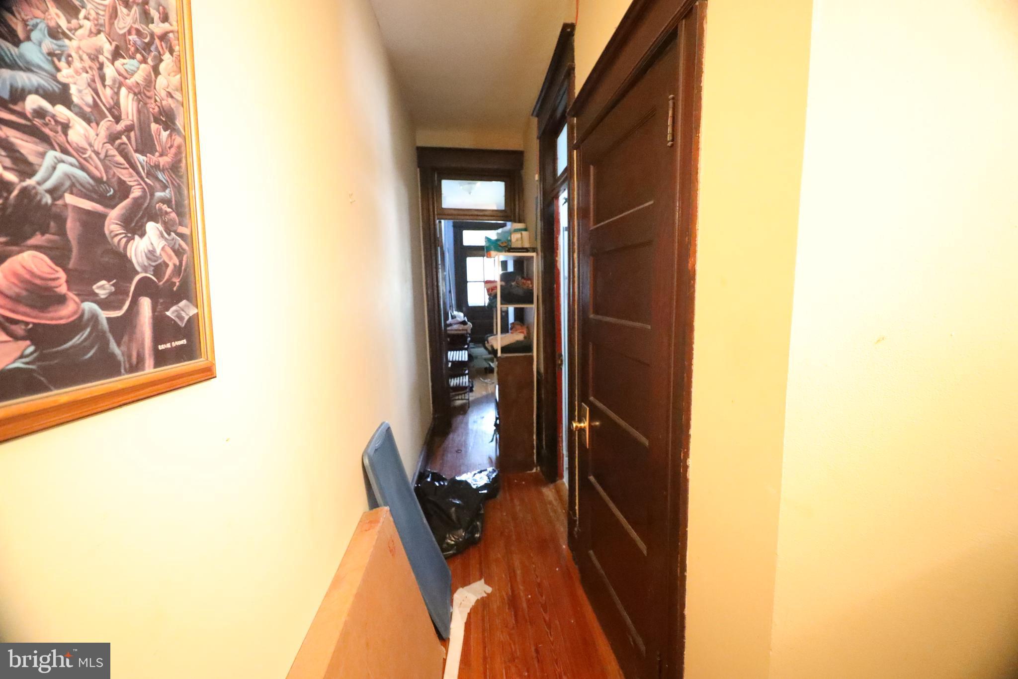 1345 Shepherd Street Northwest Washington, DC 20011 - Photo 8 of 11 a view of a hallway with wooden floor and a dining room