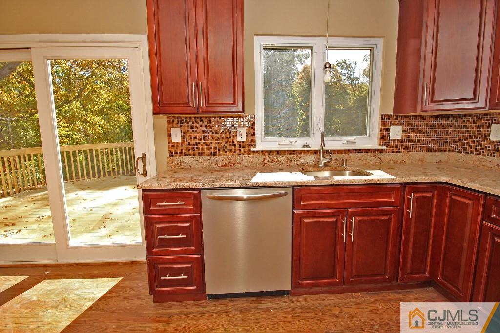 17 Brookside Road Edison, NJ 08817 - Photo 11 of 20 a kitchen with granite countertop a sink and a window