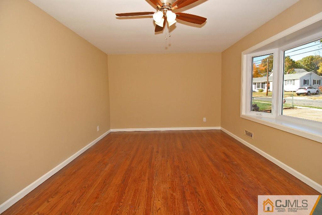 17 Brookside Road Edison, NJ 08817 - Photo 15 of 20 wooden floor in an empty room with a window