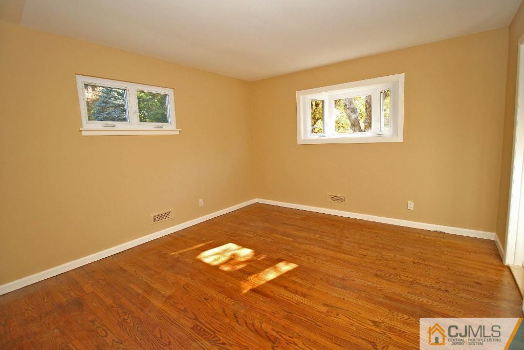 17 Brookside Road Edison, NJ 08817 - Photo 18 of 20 a view of an empty room with wooden floor and a window